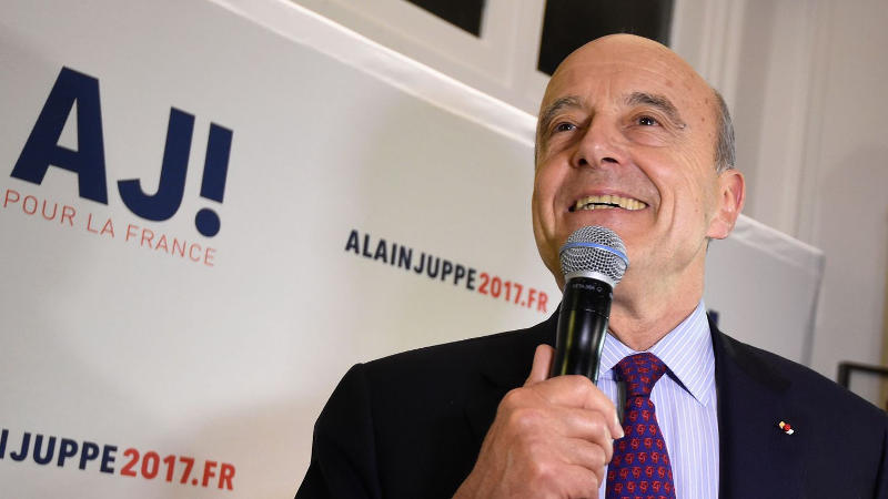 French presidential hopeful, Alain Juppé, in front of his campaign poster